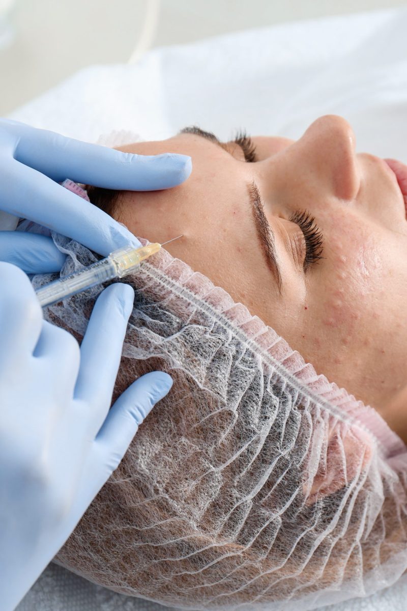Woman undergoing face biorevitalization procedure in salon, closeup. Cosmetic treatment
